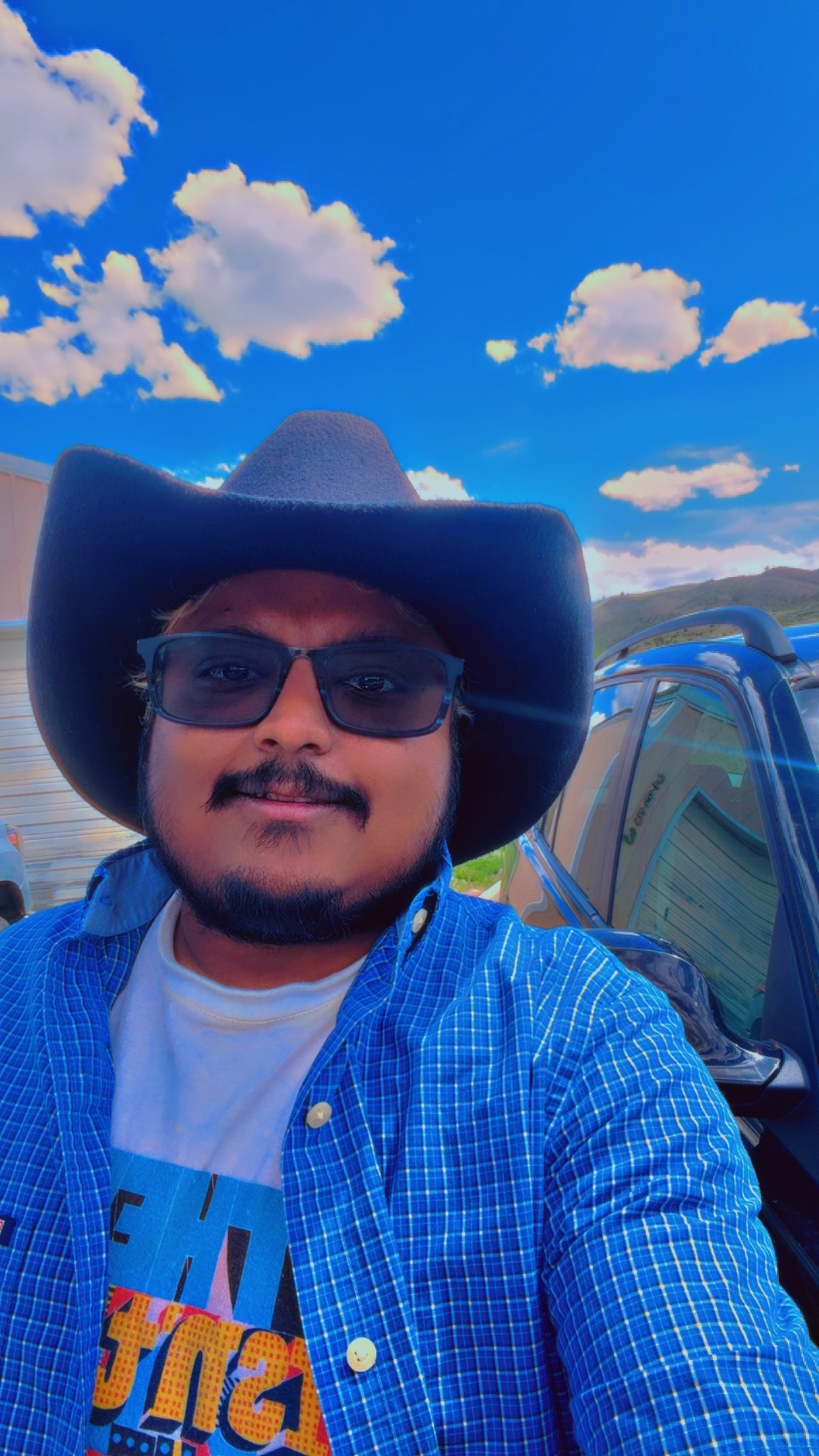 Win in a cowboy hat under Wyoming skies